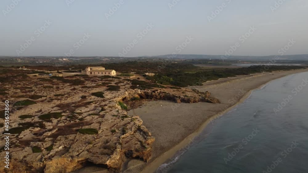 Aerial drone view of a beautiful summer sand beach and tropical sea at sunrise, summer vacation concept, Vendicari, Sicily, Italy Aerial drone view of a beautiful summer sand beach and tropical sea at sunrise, summer vacation concept, Vendicari, Sicily, Italy