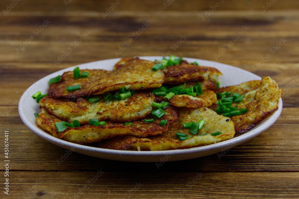 Potato pancakes on a wooden table Potato pancakes on a wooden table