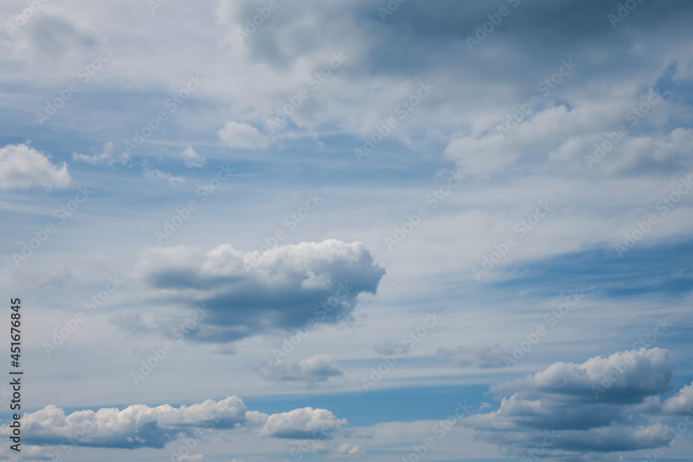 Fototapeta premium Figured clouds on blue sky. Beautiful natural background.