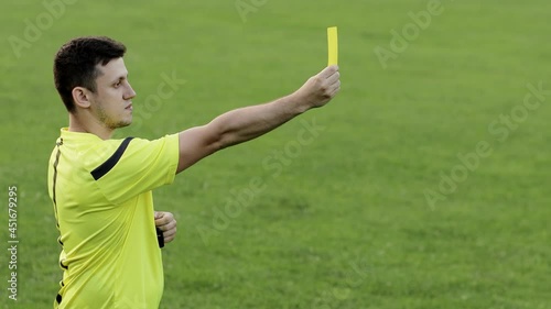 Soccer referee showing penalty and yellow card. Concept of sport, rules violation, offside.