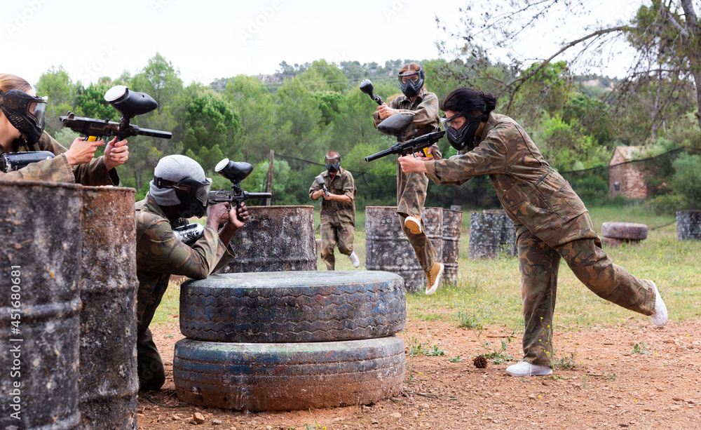 Fototapeta premium Two opposing teams facing on battlefield in outdoor paintball arena