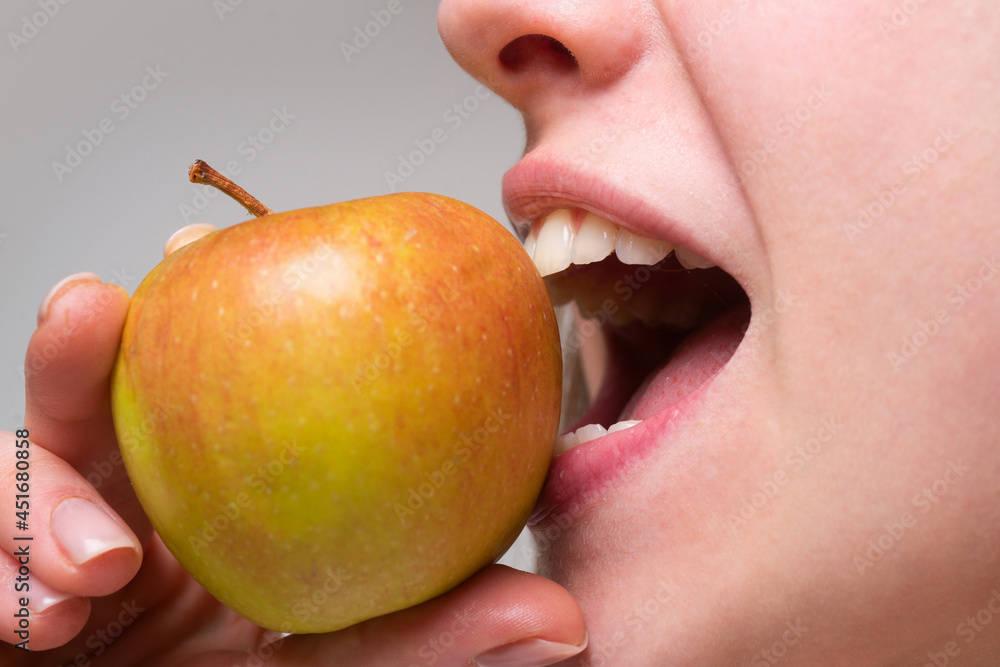 Healthy teeth and apple. Dental care. Woman biting an apple. Mouth close up. Healthy teeth and apple. Dental care. Woman biting an apple. Mouth close up.