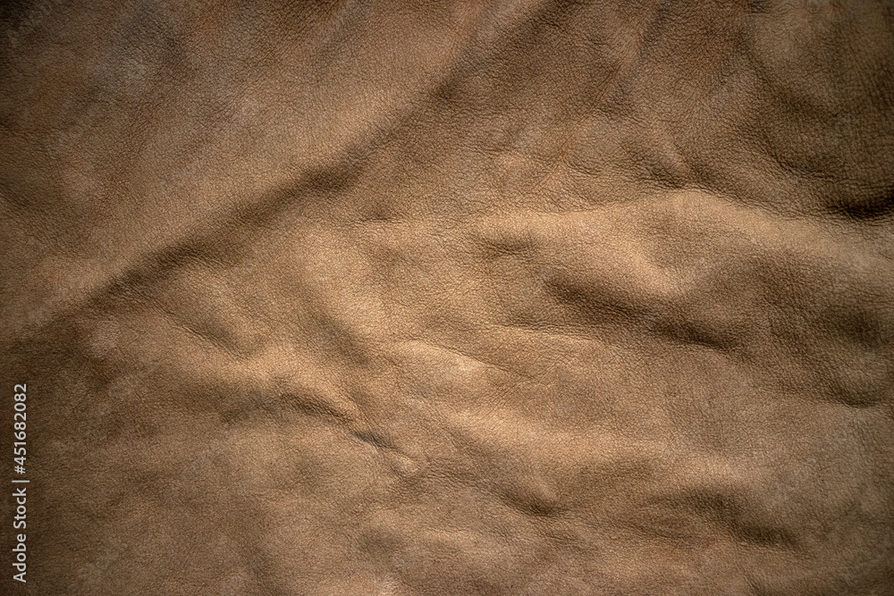 Naklejka premium The texture of natural light leather for the manufacture of individual products. A three-dimensional background with an empty space for the text.