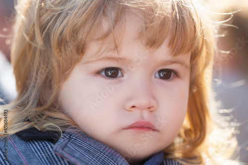 Kids portrait, close up head of serious baby child.