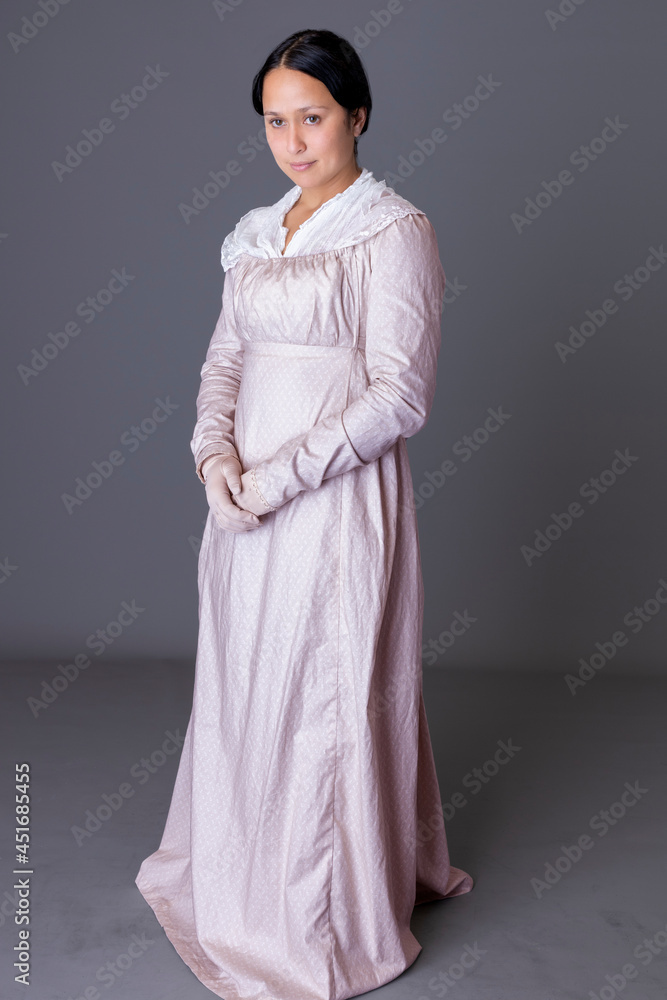A Regency woman wearing a pink cotton dress with a lace modesty shawl