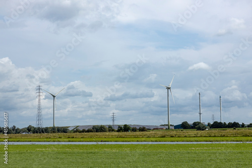 Sustainable wind turbine energy mills in Dutch river IJssel valley landscape. Bioenergy and sustainability concept.