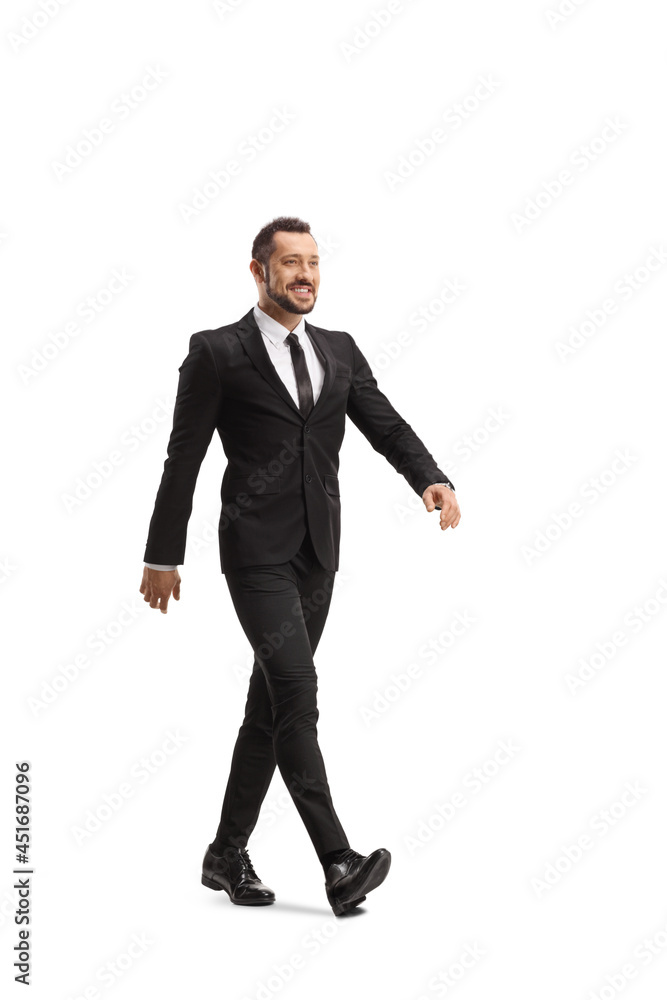Full length shot of a happy businessman walking fast Full length shot of a happy businessman walking fast