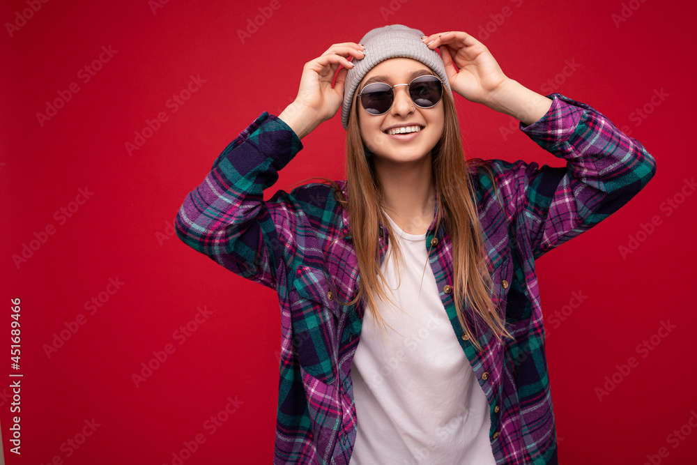 Photo shot of beautiful positive young brunette woman wearing summer casual clothes and stylish sunglasses isolated over colorful background wall looking at camera Photo shot of beautiful positive young brunette woman wearing summer casual clothes and stylish sunglasses isolated over colorful background wall looking at camera