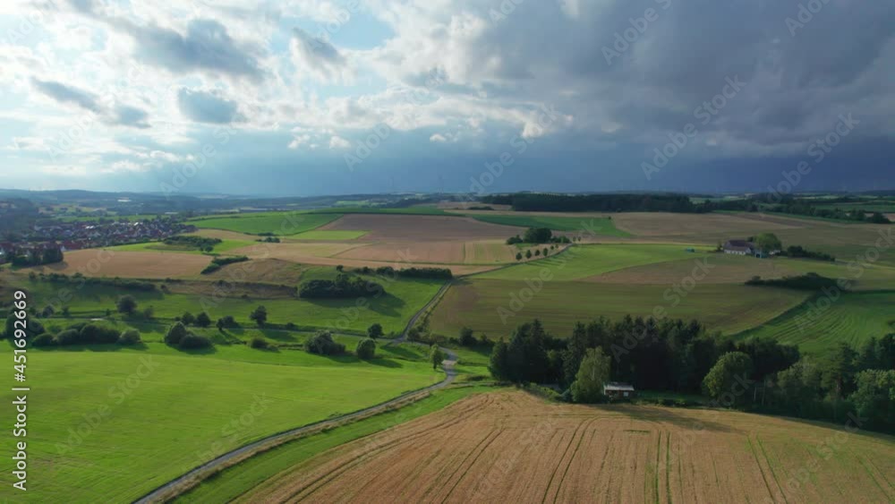 farm road in the rural landscape with wind turbines on the horizon (aerial) farm road in the rural landscape with wind turbines on the horizon (aerial)