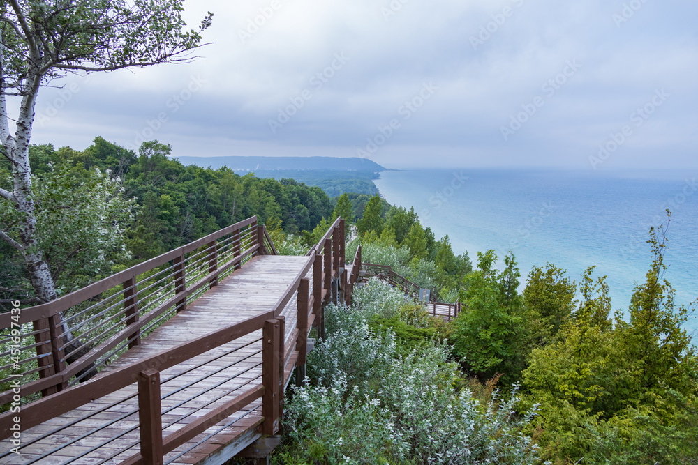 Wooden staircase down the side of a hill with Lake Michigan in background