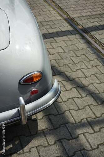 Rücklicht eines deutschen Roadster und Sportwagen der Fünfzigerjahre in Silber Metallic auf Verbundpflaster im Sommer bei Sonnenschein in der Klassikstadt im Stadtteil Fechenheim in Frankfurt am Main photo