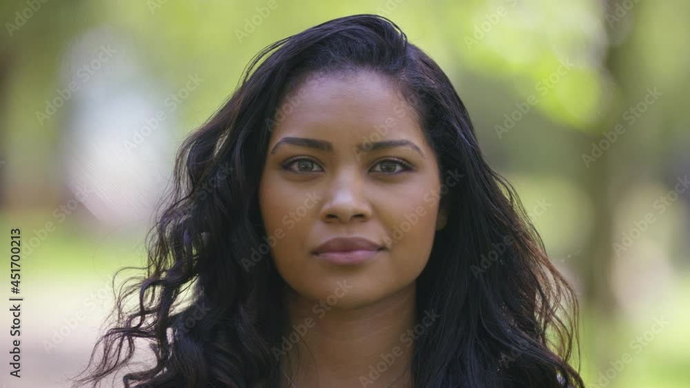 Portrait of young black female looking to camera with a blank expression Portrait of young black female looking to camera with a blank expression