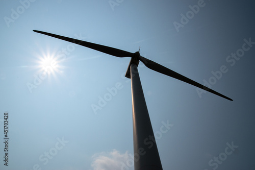 Blades of a wind turbine seen from below with a bright sun © ALAN