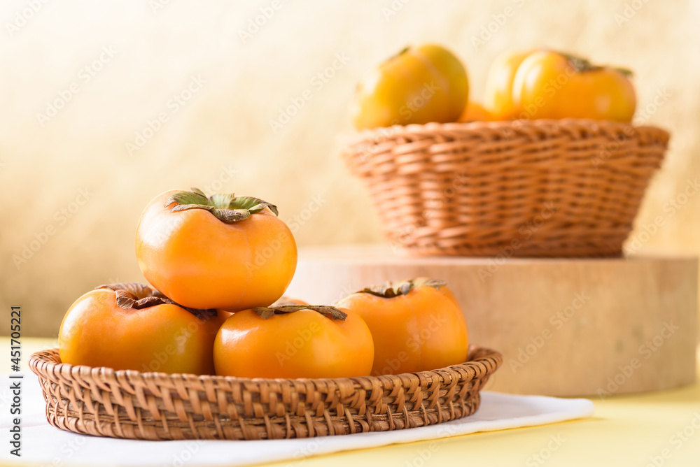 Persimmon fruit on golden background, tropical fruit mostly in Southeast Asia, refreshing and healthy eating sweet taste