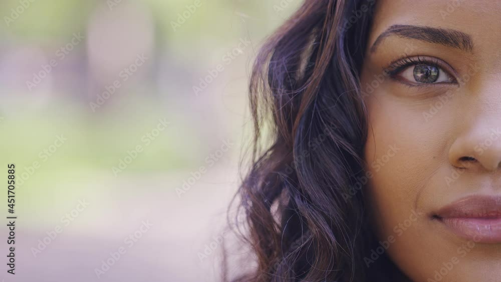 Half face portrait of attractive female looking to camera with a blank expression, with space for text Half face portrait of attractive female looking to camera with a blank expression, with space for text