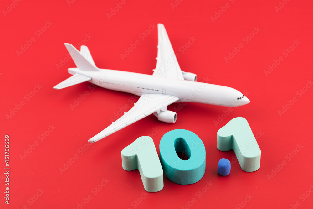 Airplane and numbers on October 1st on a red background Airplane and numbers on October 1st on a red background