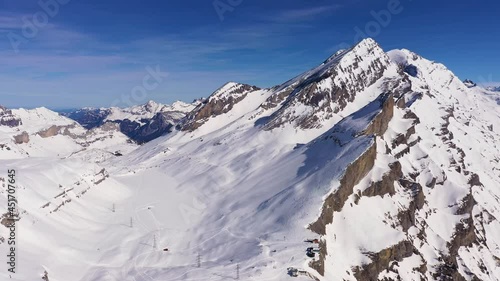 Aerial drone footage of the famous Gemmi pass in the alps in Canton Valais above the Leukerbad station on a sunny winter day in Switzerland.  photo