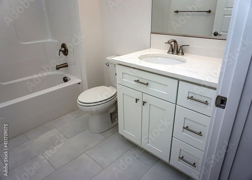 Toilet  sink and shower in new modern home bathroom