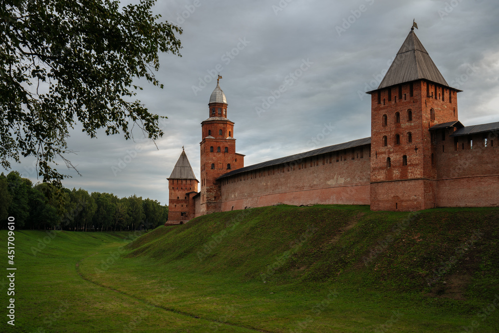 View of the wall of the Novgorod Kremlin, the Knyazhaya Tower, the Kokui Tower and the Pokrovskaya Tower on an early cloudy summer morning, Veliky Novgorod, Novgorod Region, Russia View of the wall of the Novgorod Kremlin, the Knyazhaya Tower, the Kokui Tower and the Pokrovskaya Tower on an early cloudy summer morning, Veliky Novgorod, Novgorod Region, Russia
