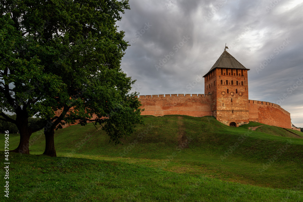 View of the wall of the Novgorod Kremlin and the Dvortsovaya  Tower on an early cloudy summer morning, Veliky Novgorod, Novgorod region, Russia