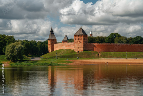 View of the wall of the Novgorod Kremlin, the Dvortsovaya and Spasskaya Towers, the city beach from the Volkhov River on an early cloudy summer morning, Veliky Novgorod, Novgorod Region, Russia