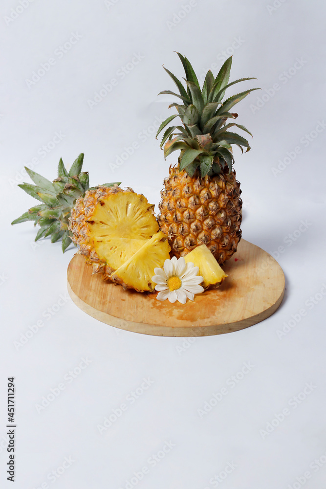 Whole pineapple isolated on a bright background. Close-up view of fresh and delicious pineapple. Overripe pineapples that begin to rot will release a sweet, honey-like liquid. Focus blur. Pineapple mo Whole pineapple isolated on a bright background. Close-up view of fresh and delicious pineapple. Overripe pineapples that begin to rot will release a sweet, honey-like liquid. Focus blur. Pineapple mo