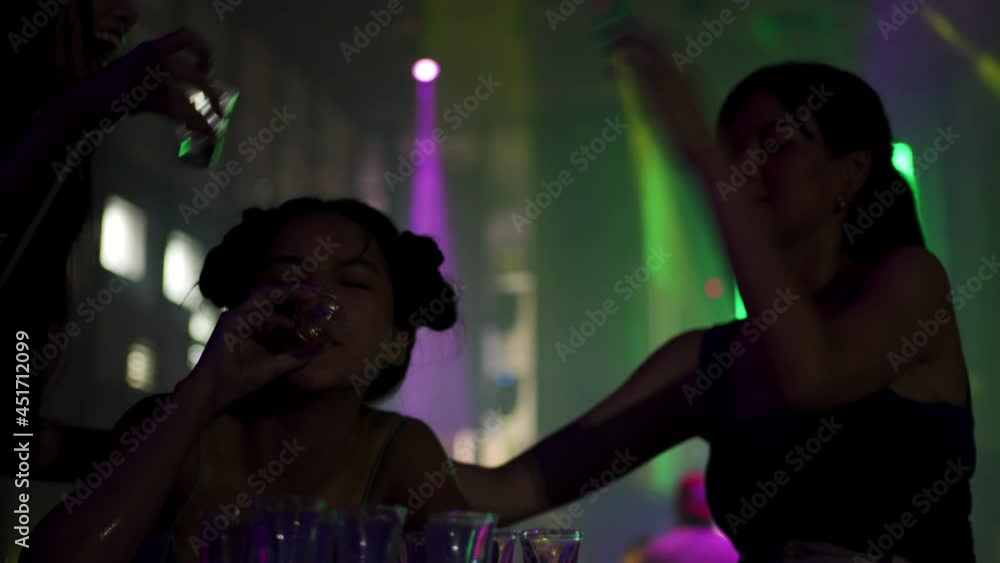 4K Group of Beautiful Asian woman dancing to the music with drinking alcoholic drink on table at night club. Pretty girl friends enjoy and having fun nightlife crazy dance together at nightclub party 4K Group of Beautiful Asian woman dancing to the music with drinking alcoholic drink on table at night club. Pretty girl friends enjoy and having fun nightlife crazy dance together at nightclub party