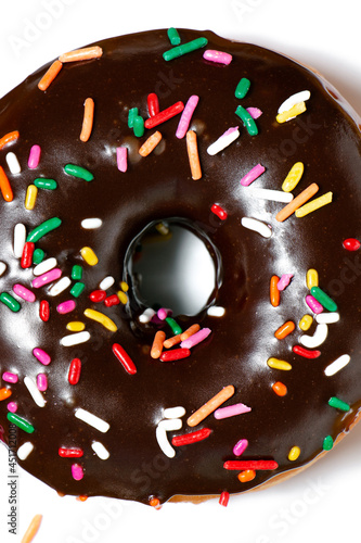 Close up of a chocolate frosted donut with rainbow sprinkles