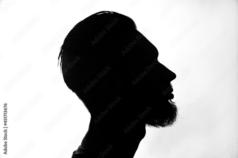 The silhouette of a man with a beard.