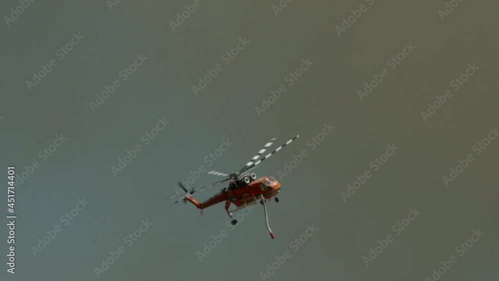 Big fire at Varimbombi, Athens, Greece, August 03, 2021. Firefighting helicopter moves in black smoke 120fps Big fire at Varimbombi, Athens, Greece, August 03, 2021. Firefighting helicopter moves in black smoke 120fps