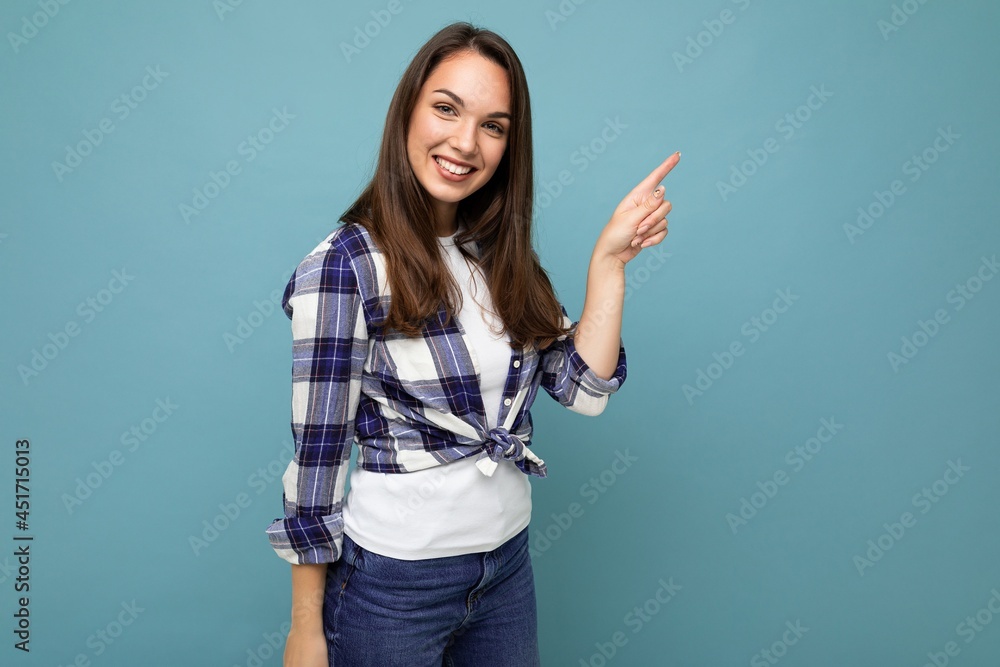 Photo of attractive positive smiling young woman pointing finger up at copyspace presenting ads promo with wow omg sincere emotions wearing good look outfit isolated over background with free space Photo of attractive positive smiling young woman pointing finger up at copyspace presenting ads promo with wow omg sincere emotions wearing good look outfit isolated over background with free space