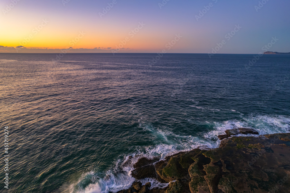Aerial sunrise over the sea with clear skies Aerial sunrise over the sea with clear skies