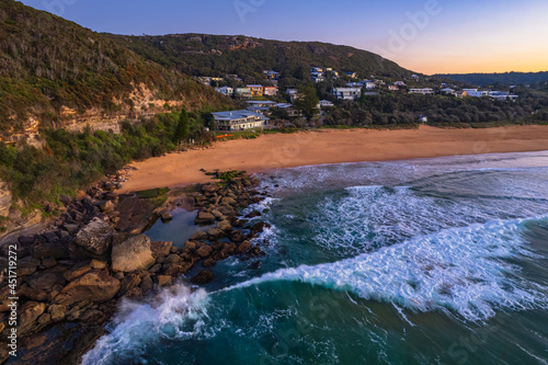 Aerial sunrise rocky shorescape at the beach