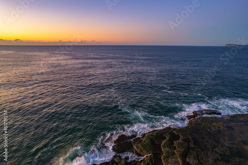Aerial sunrise over the sea with clear skies