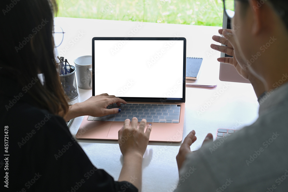 Back view of two business colleagues working together with computer laptop. Back view of two business colleagues working together with computer laptop.