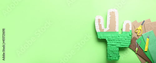 Handmade pinata and tools on color background with space for text