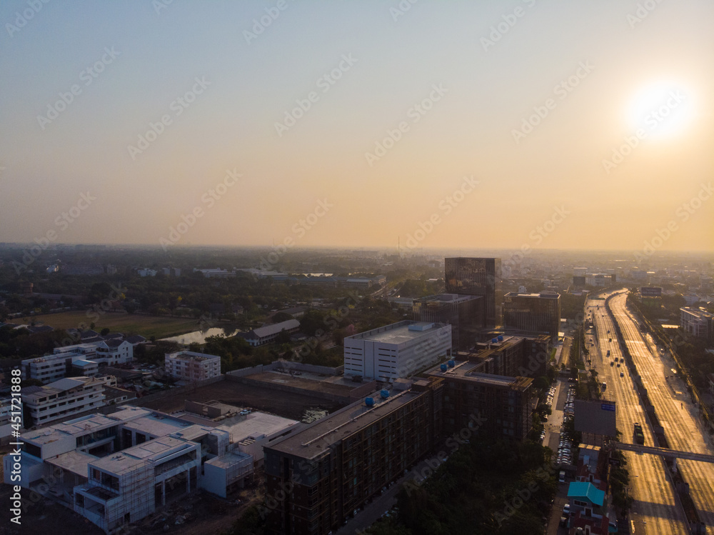 Aerial view morning sunrise city building with transport road