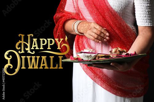 Indian woman holding tray w...