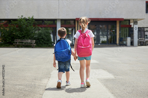Back to school. Boy and girl go to school with backpacks. The beginning of the school year, children go to lessons