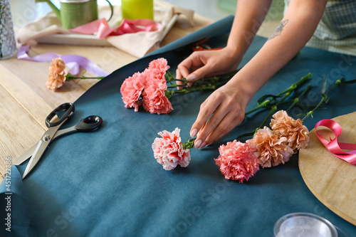 Female florist making bouqu...