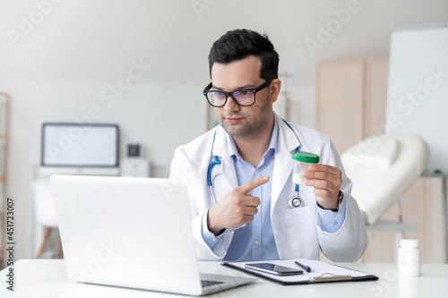 Young doctor video chatting...