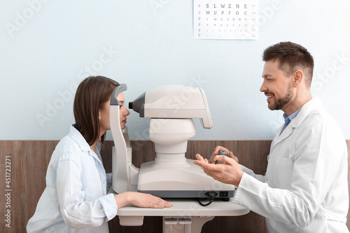 Ophthalmologist examining y...