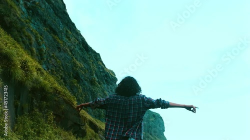 young guy rock climber on the cliff