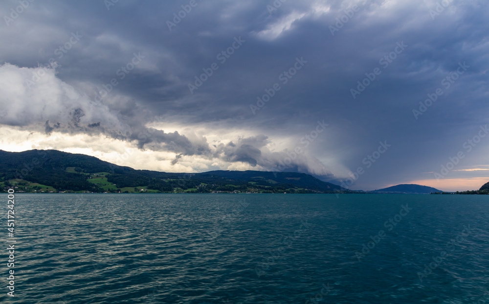 Lake attersee at storm cloudy sky with alps mountain. Moody weather, Austria, salzburg region.