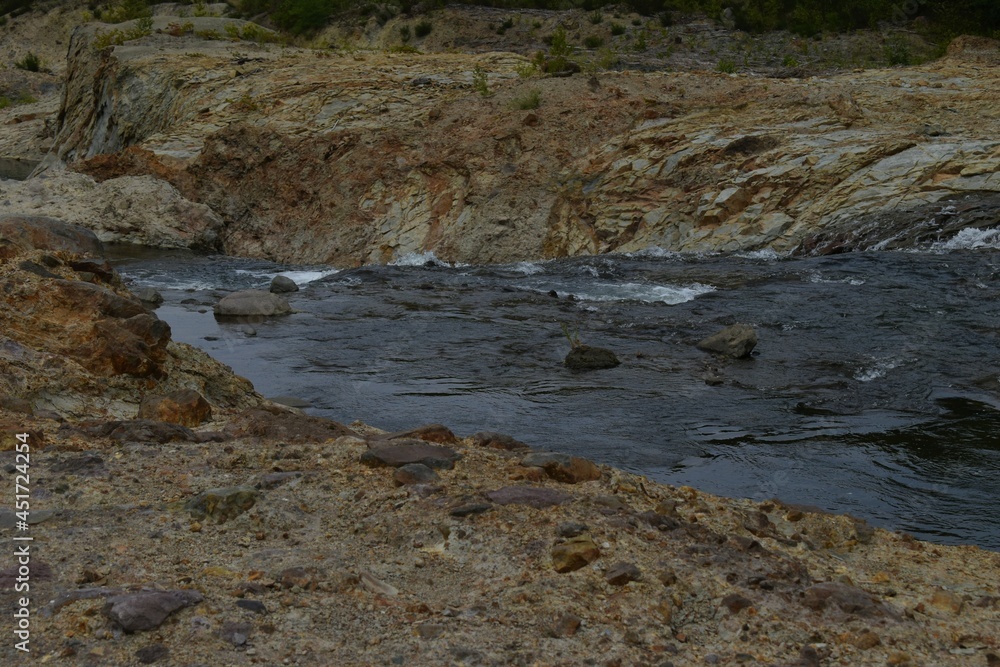 The natural water flowing river along with the rough rock mountain in Sapporo Japan The natural water flowing river along with the rough rock mountain in Sapporo Japan