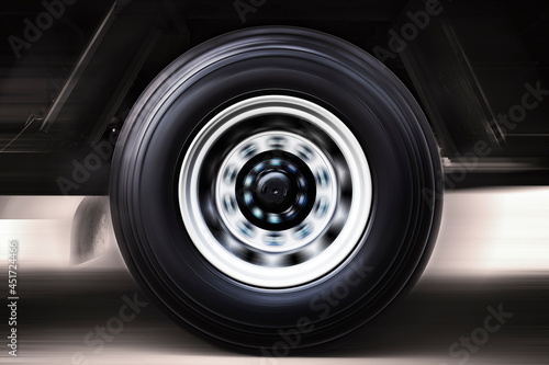 Speeding Motion of Truck Wheels Spining. Truck Driving on The Road. Industry Freight Truck Transportation.