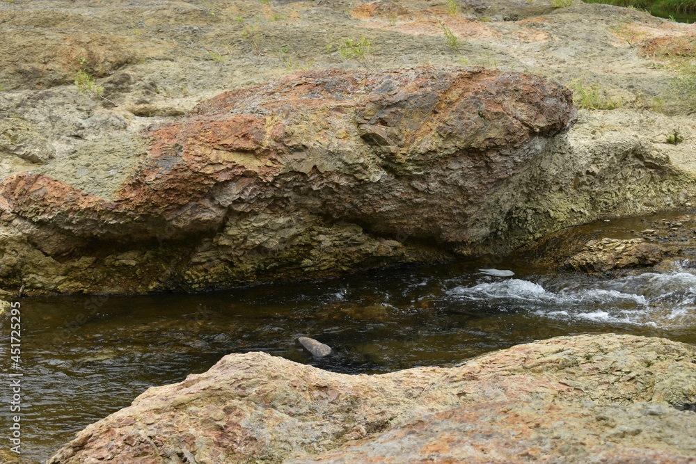 The small stream water flowing among the massive rocks in Sapporo Japan The small stream water flowing among the massive rocks in Sapporo Japan