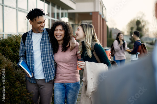 Group of happy university friends laugh and have fun at campus. © Drazen