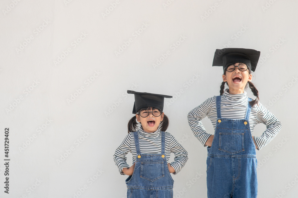 Siblings children girl graduation with cap