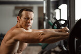 Portrait of a senior muscular man in a gym